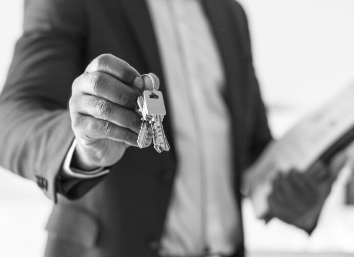 Real estate agent handing the house key