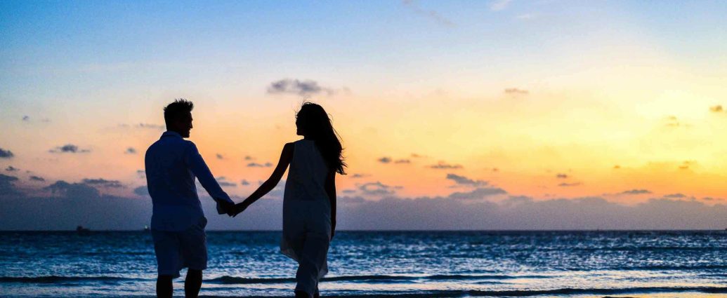Photo by Asad Photo Maldives: https://www.pexels.com/photo/man-and-woman-holding-hands-walking-on-seashore-during-sunrise-1024960/