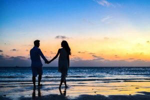 Photo by Asad Photo Maldives: https://www.pexels.com/photo/man-and-woman-holding-hands-walking-on-seashore-during-sunrise-1024960/