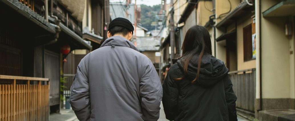 Photo by Ryutaro Tsukata: https://www.pexels.com/photo/couple-walking-on-street-with-concrete-tile-and-old-houses-6249393/
