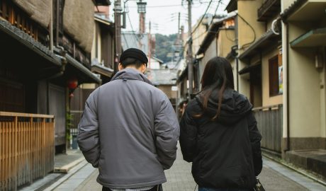 Photo by Ryutaro Tsukata: https://www.pexels.com/photo/couple-walking-on-street-with-concrete-tile-and-old-houses-6249393/