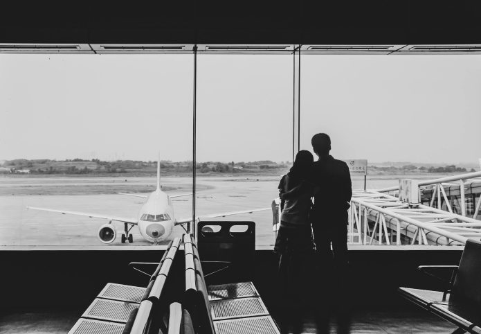 Photo by Cheng Shi Song: https://www.pexels.com/photo/back-view-of-couple-embracing-at-airport-21235995/