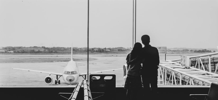 Photo by Cheng Shi Song: https://www.pexels.com/photo/back-view-of-couple-embracing-at-airport-21235995/