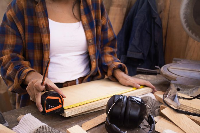 Photo by Los Muertos Crew: https://www.pexels.com/photo/close-up-photo-of-woman-measuring-a-wood-plank-8447802/