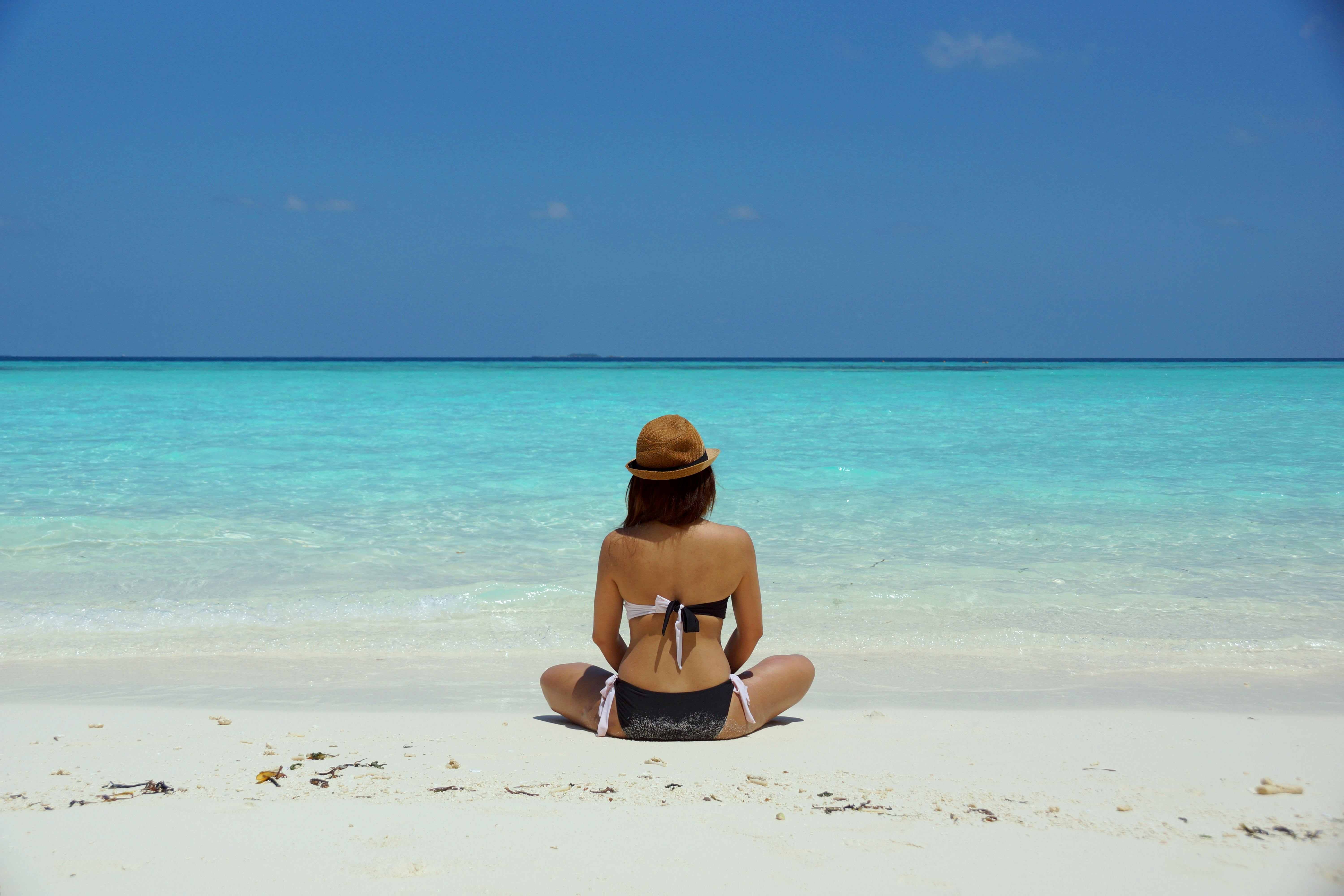 Photo by Wendy Hero: https://www.pexels.com/photo/woman-wearing-black-and-white-brassiere-sitting-on-white-sand-67818/