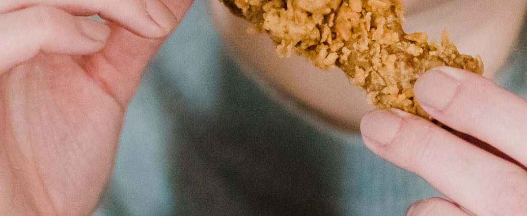 Photo by Tim Samuel: https://www.pexels.com/photo/hungry-woman-biting-fried-delicious-chicken-6697382/