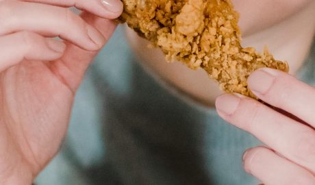 Photo by Tim Samuel: https://www.pexels.com/photo/hungry-woman-biting-fried-delicious-chicken-6697382/