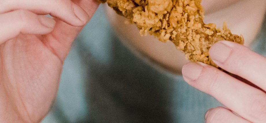 Photo by Tim Samuel: https://www.pexels.com/photo/hungry-woman-biting-fried-delicious-chicken-6697382/