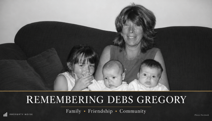 Black-and-white photograph of Debs Gregory seated with three children, above the words “Remembering Debs Gregory”.